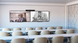 An image of a large meeting space with three rows of tables and chairs. There are two screens mounted to a wall at the front of the room. A Poly Studio X70 is mounted above the screens.