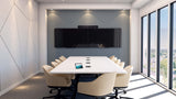 An image of a large meeting room with a table and eleven chairs. On the table there is a Poly TC8 touch controller. At the far end of the table, there are two screens mounted on a wall. A Poly Studio X70 is mounted above the screens.
